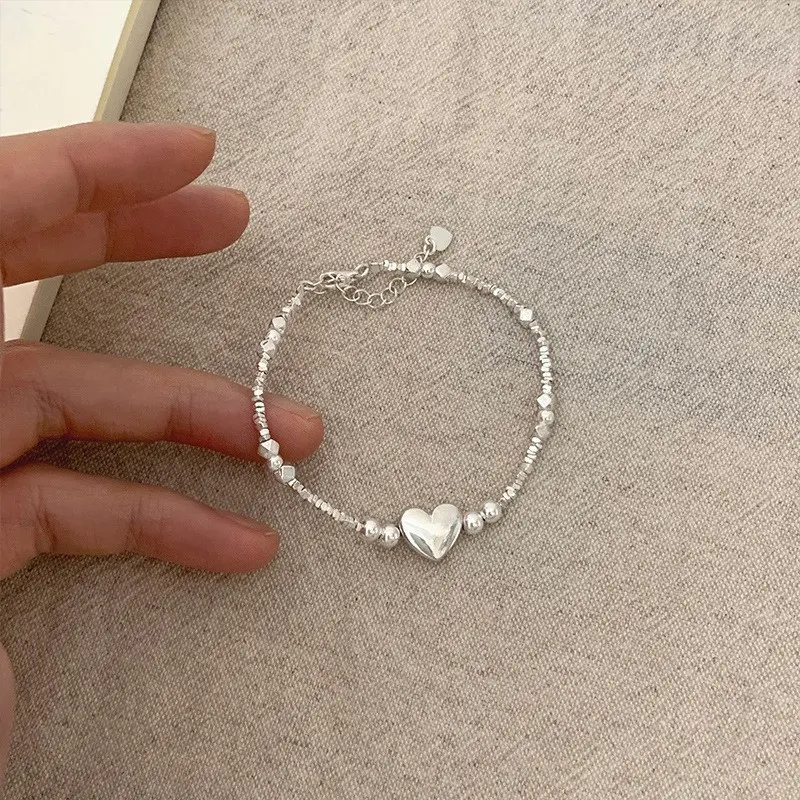 Bracelet cœur en argent sterling, petites pièces d'argent, design féminin de niche, un bijou charmant pour femmes.