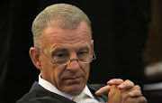 Gerrie Nel said he was astounded that someone accused of killing his wife with a firearm was given a firearm by the SAPS.