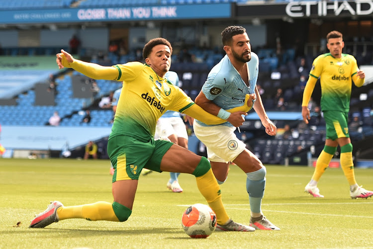 Manchester City's Riyad Mahrez in action with Norwich City's Jamal Lewis