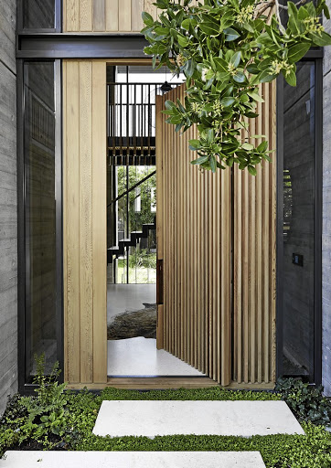 The front door sets the tone for the interiors, combining beautifully cast concrete, imprinted with a timber grain.