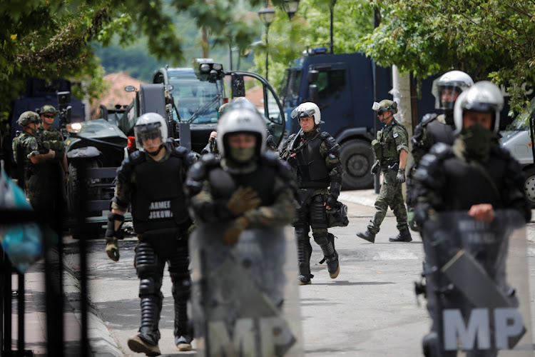 Polish Kosovo Force soldiers keep guard at a municipal office in Zvecan, Kosovo, on May 30 2023. Picture: OGNEN TEOFILOVSKI/REUTERS