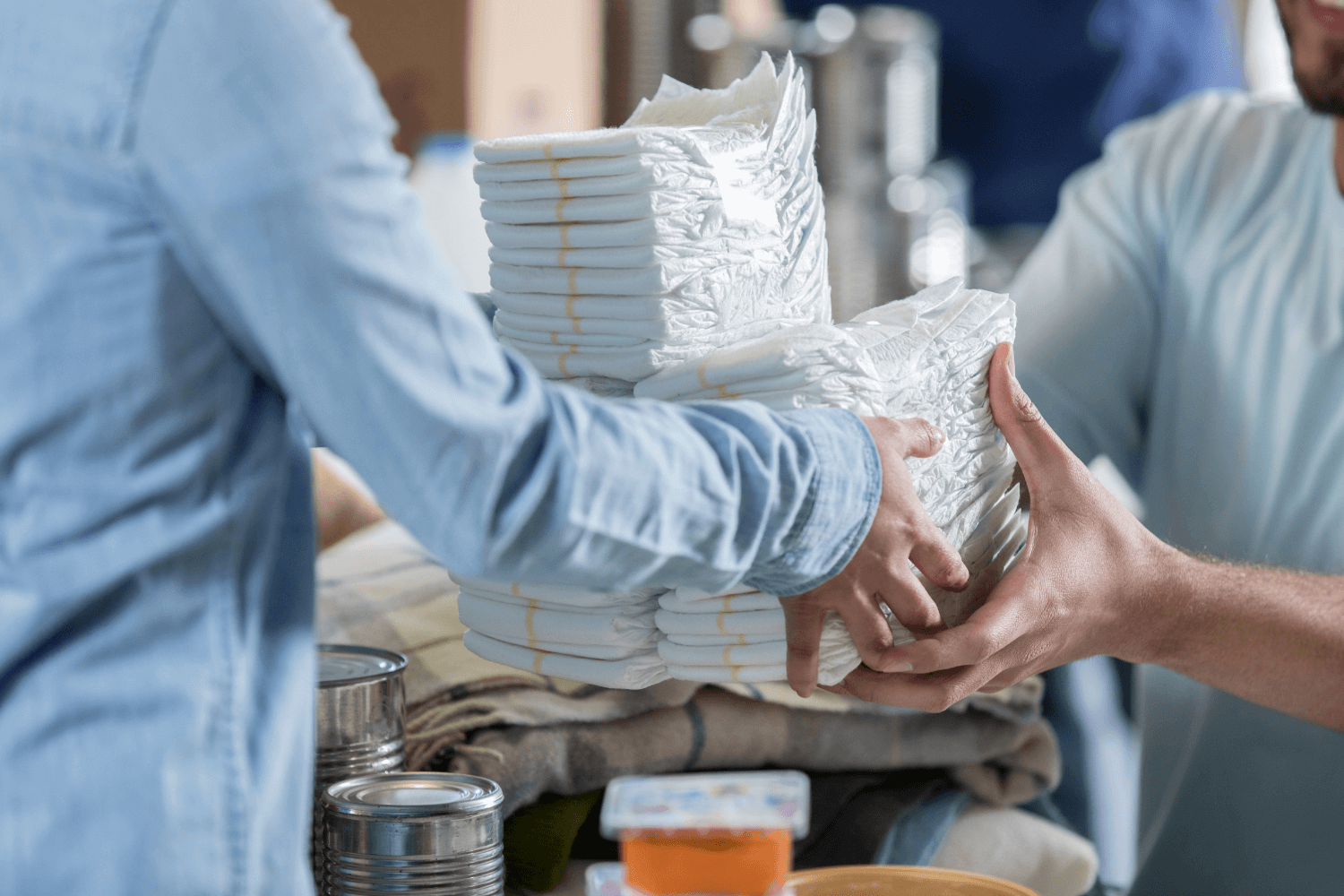 Man donating a stack of diapers