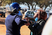 Police arrest a health worker during a protest against economic hardship and poor working conditions during the coronavirus disease (Covid-19) outbreak in Harare, Zimbabwe on July 6 2020. 