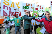 SPLIFFING GOOD FUN:    Jules Stobbs  stands next to members of the Concerned Young People of SA  outside the Pretoria High Court yesterday. Stobbs and his partner Myrtle Clarke are mounting  a legal  challenge to    cannabis smoking laws Picture: Alaister Russell