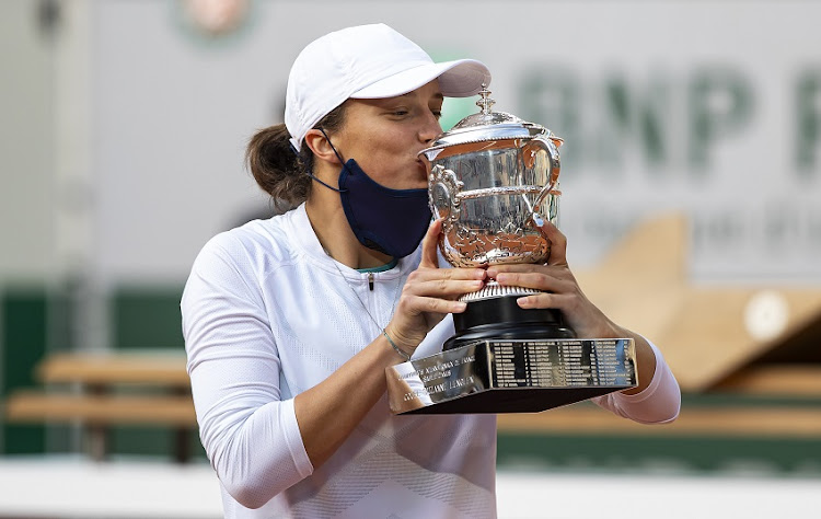 A file photo of Iga Swiatek of Poland celebrating with the trophy after her victory over Sofia Kenin of the United States in the final of the women’s singles at Roland Garros on October 10, 2020 in Paris, France.