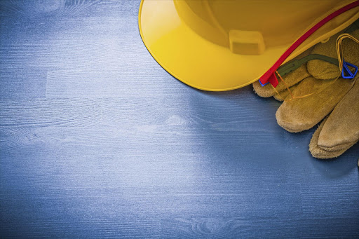 A mining hard hat and gloves.