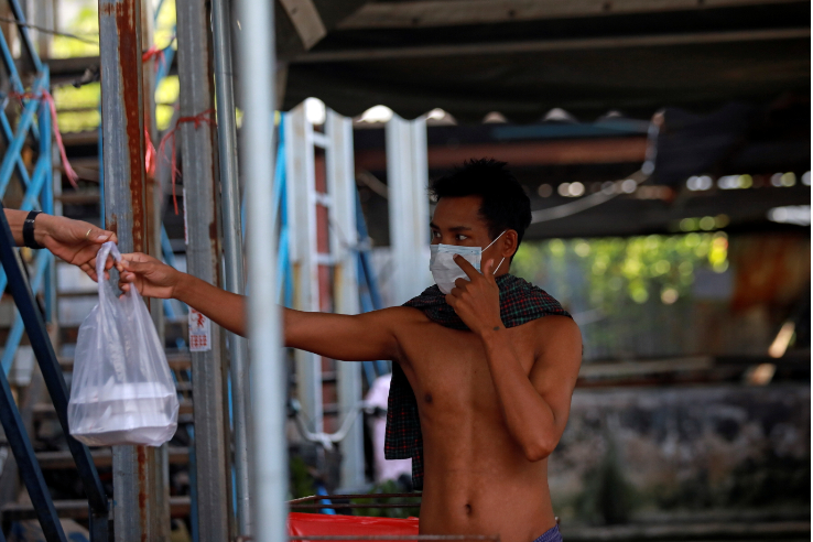 Myanmar migrant workers share food as they have been stuck for two weeks due to lockdown measures after more than a thousand cases were detected in the workers' dormitory in Bangkok, Thailand on May 24 2021.