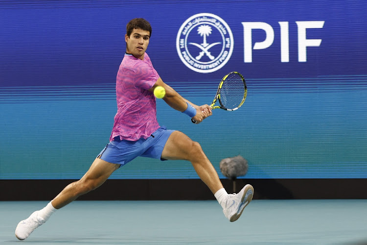 Carlos Alcaraz (ESP) hits a backhand against Lorenzo Musetti (ITA) on day nine of the Miami Open at Hard Rock Stadium on March 26, 2024