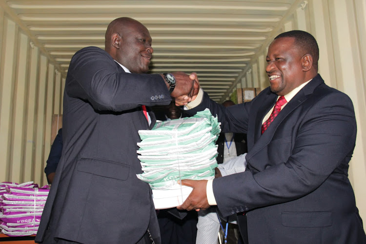 Mining, Blue Economy and Maritime Affairs Cabinet secretary Salim Mvurya, handing over KCPE papers at the Kisumu Central DCC container on Monday, November 28.