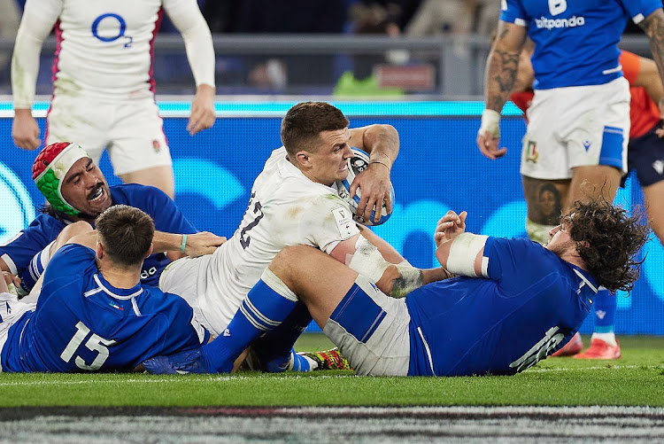 Henry Slade of England competes for the ball with Edoardo Padovani, Epalahame Faiva and Tiziano Pasquali of Italy in the Six Nations match at Stadio Olimpico in Rome, Italy on February 13 2022. Italy's 33-0 defeat extended their losing streak to 34 in the Six Nations.