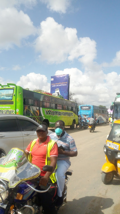 Buses plying Garissa-Nairobi route packed outside their booking offices on Tuesday.