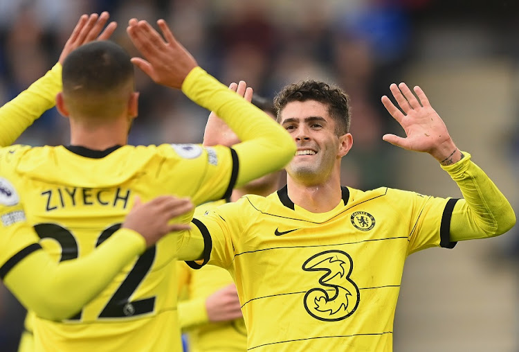 Christian Pulisic celebrates with Hakim Ziyech of Chelsea after scoring Chelsea's third goal in their Premier League match against Leicester City at King Power Stadium in Leicester on November 20 2021.