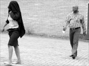 COVER BLOWN: A testing station official is led away by organised crime unit spokesman Leonard Hlathi after she was arrewsted at her Mbombela office yesterday. Pic. Andrew Hlongwane. © Sowetan.