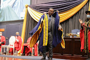 Prof Zeblon Vilakazi being robed by Wits chancellor Dr Judy Dlamini in the presence of former Wits chancellor Dikgang Moseneke and chairperson of the Wits Council Isaac Shongwe.