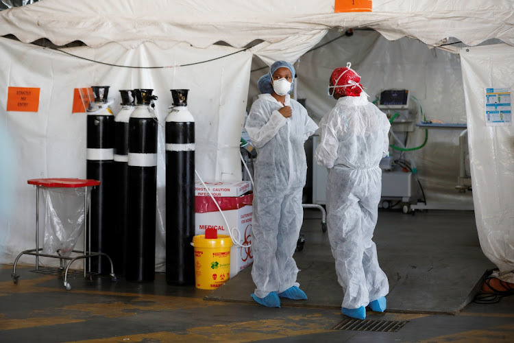 Healthcare workers chat at a temporary ward set up during the coronavirus disease (Covid-19) outbreak, at Steve Biko Academic Hospital in Pretoria, South Africa, January 19, 2021.