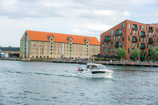 copenhagen-christianshavn.jpg - A tour boat slices through the canal separating the Christianshavn and Nyhavn districts.