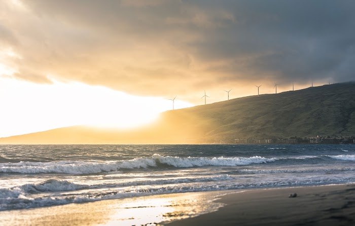 Wind turbines on bluff over ocean