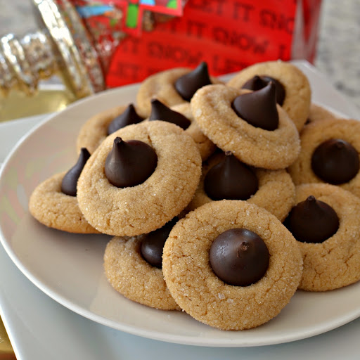 Have you started planning your Christmas cookie trays?  If not you had better hurry.  Christmas is just a few weeks away.  These scrumptious Peanut Butter Blossom Cookies are a must make for all my cookie loving friends and neighbors.  