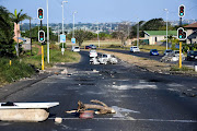 Burnt cars and debris on the Phoenix highway in the aftermath of the July 2021 riots. File photo.