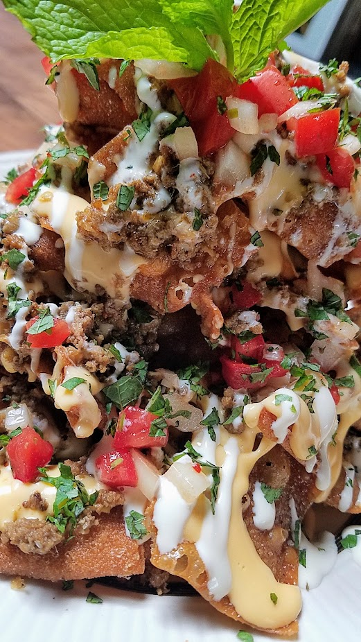 Expatriate Nachos, available at brunch Sat Sun 10am - 2pm and early and late night on weekdays only (between 5-6 pm or after 10 pm only). Fried wonton chips, thai chili cheese sauce, spicy lemongrass beef, crema, kaffir lime & tomato salsa, herbs