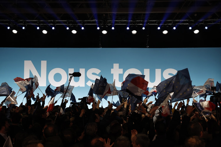 Supporters of French President Emmanuel Macron react after early results in the first round of the 2022 French presidential election in Paris, France, on April 10 2022.