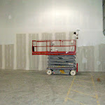 Painting wall after room was created with steel beam, drywall, and plaster