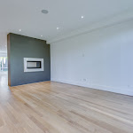 Modern living area with two sided fireplace and white oak hardwood flooring