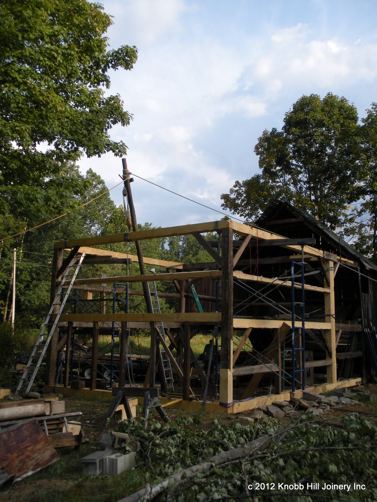 After a long minute of pulling, the new gable wall was lifted into place with the gin pole.