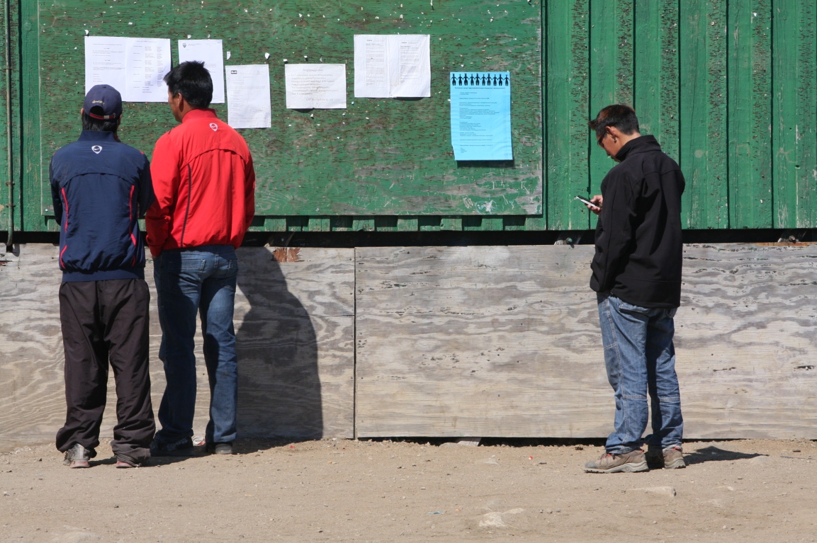 Local crowd reading newest advertisements in the village of 300 people