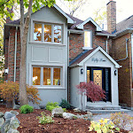 New home renovation showing front of house detailing stone bordered landscaping.