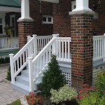 Porch renovation with wooden railing and steps painted grey and white