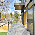 Glass railing on back deck with huge glass sliding doors