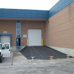 Completed look of paved elevated entrance to large industrial sized door