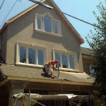 Roofer adding new tiles during home renovation