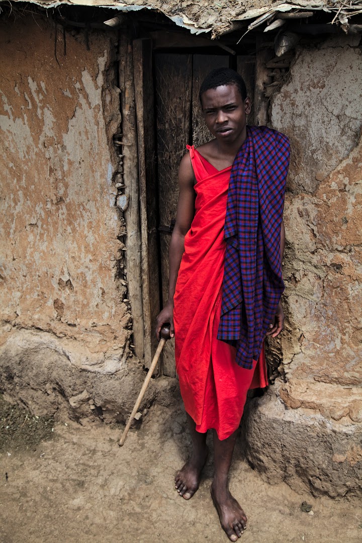 Young Masai in front of his mother's hut