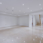 Polished concrete flooring in downstairs living space with hallway