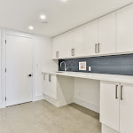 Laundry room in the basement with polished concrete