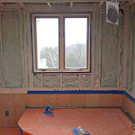 Foam insulation applied in between wall studs;
outside wall with a window shown