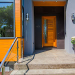 Polished porch entrance in front of main door with glass railings