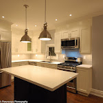 Shaker style kitchen cabinets with dark island and white quartz countertops