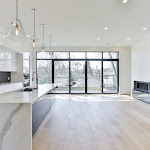 Huge modern windows looking out to the deck and backyard