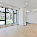 Living area with large window looking at the front lawn