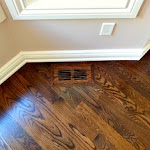 Wooden heating vent blended into hardwood