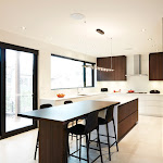 Modern kitchen with breakfast table on the countertop and window looking out to the back deck