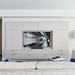 Living room with modern floating wall cabinetry around the TV