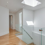 White oak hardwood flooring in 2nd floor hallway with glass railings