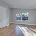 Big windows in bedroom with white oak flooring