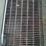 Grate showing sum pump drain tubes