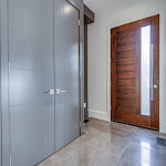Huge front door and polished tiles in house entrance