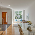 Entrance area along with living area and dining room, that has white oak hardwood flooring